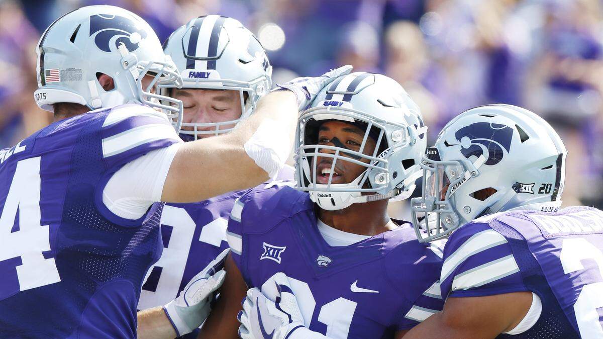 K-State defensive back Kendall Adams (21) celebrates after an interception touchdown against Charlotte. (September 9, 2017)