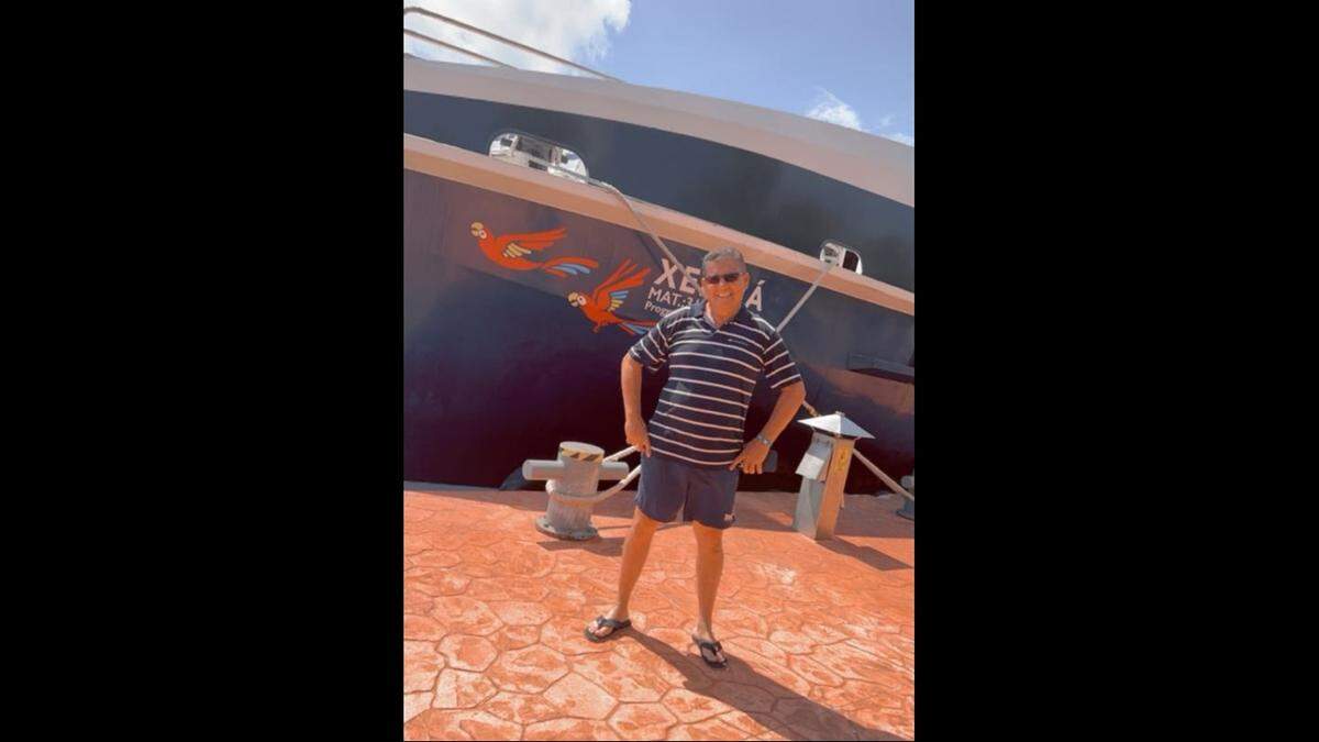 Hani Sami Stefan posing in front of a yacht.