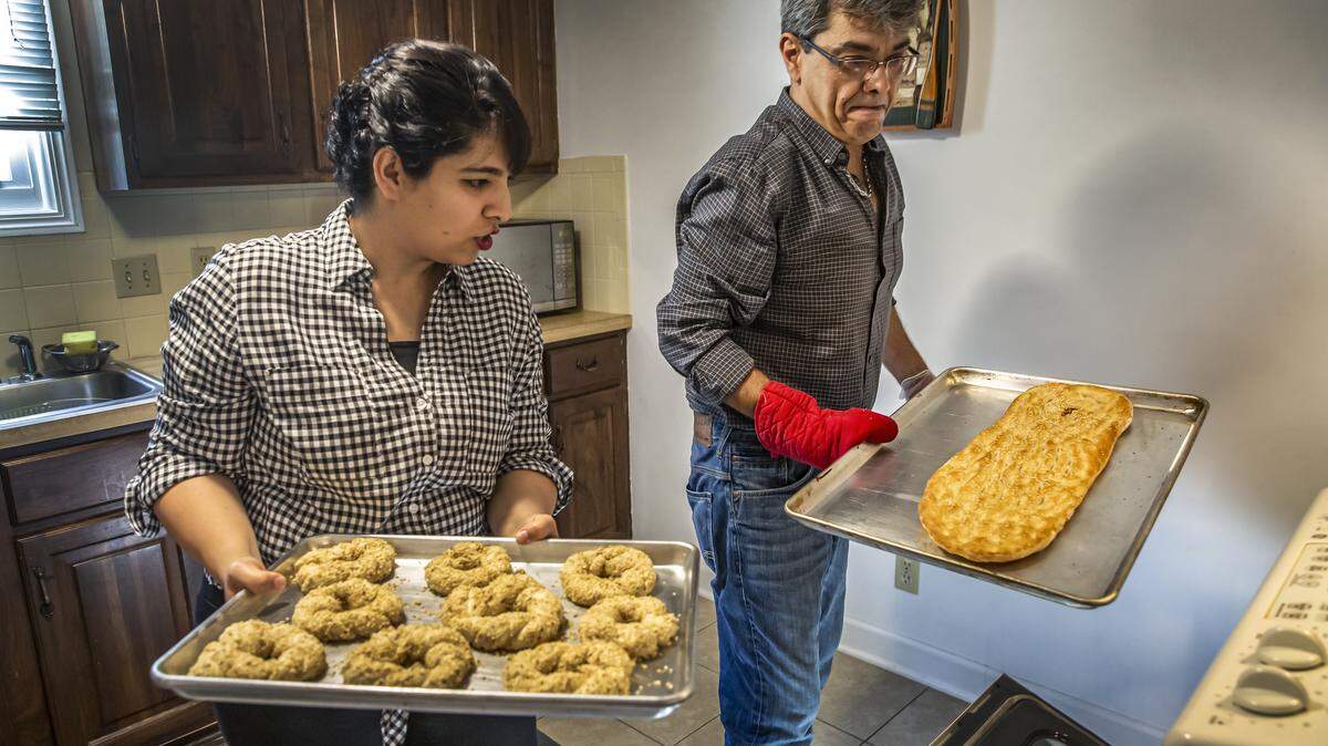 Omid Hashemi and his wife, Mahshid Alipour Hashemi, make Turkish Simit, left, and Barbari, a Persian flatbread, at their east Wichita home. The two are opening Aria Bakery at Normandie Square by mid-September.