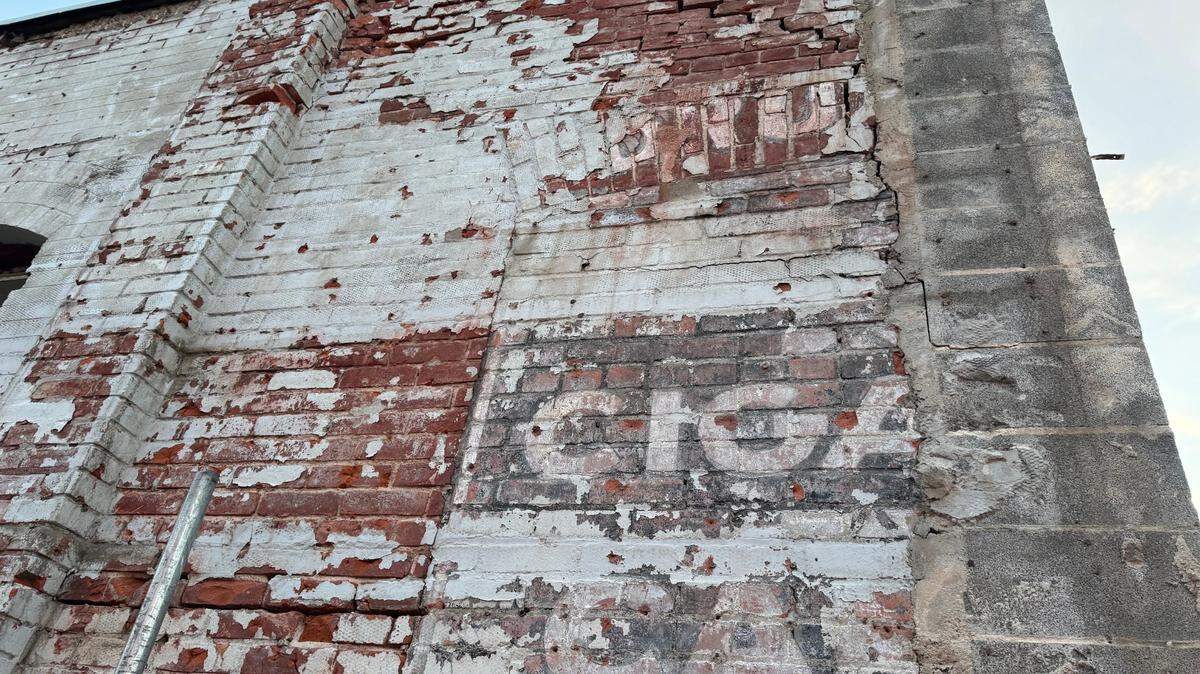 These ghost signs, which appear to have remnants of the words “drugs,” “cigars” and possibly “candy” or “cafe,” were revealed recently when construction started on the building at the southwest corner of Douglas and Seneca. This is the Seneca-facing side of the building.