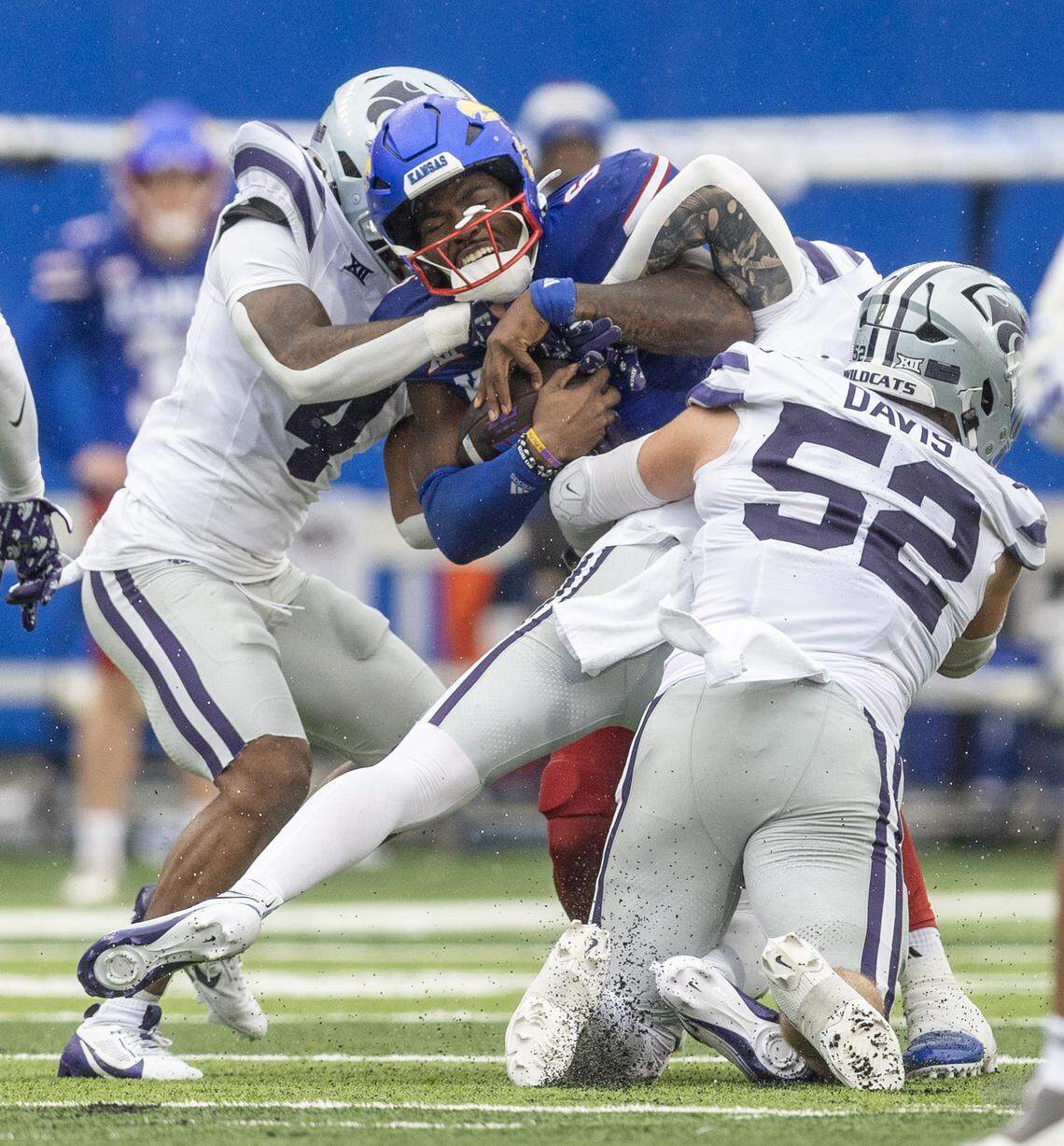 Kansas quarterback Jalon Daniels is tackled by a trio of Kansas State defenders during the first half of a game at David Booth Kansas Memorial Stadium on Saturday, Oct. 25, 2025.