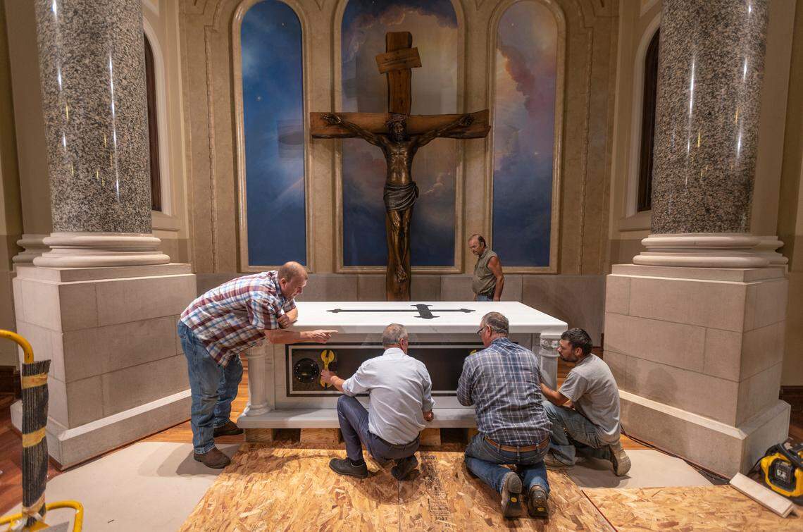 A crew from Simpson Construction finishes putting into place the 5,400-pound tomb inside the Cathedral of the Immaculate Conception in Wichita. It will serve as the final resting place for Father Emil Kapaun. Kapaun, a recipient of the Medal of Honor and candidate for sainthood, died in a North Korean POW camp 70 years ago. His remains were identified earlier this year and were turned over to his family on Sept. 21 in Hawaii, the start of his journey home to Kansas.