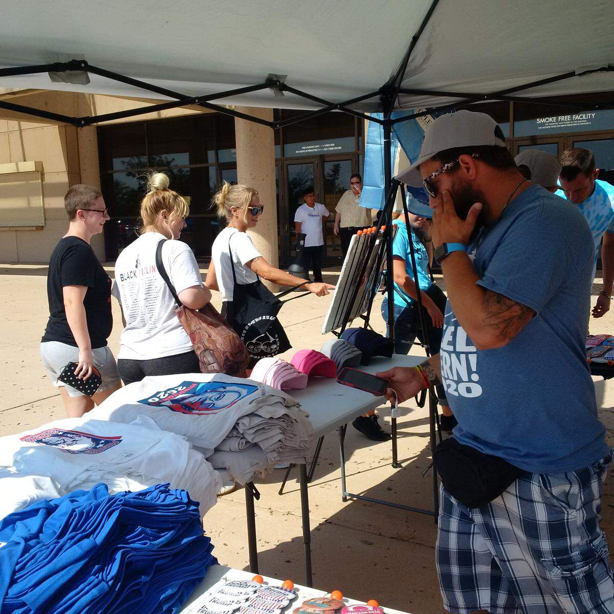 T-shirt vendor Kevin McPride did a brisk business outside Bernie Sanders rally for congressional candidate James Thompson.