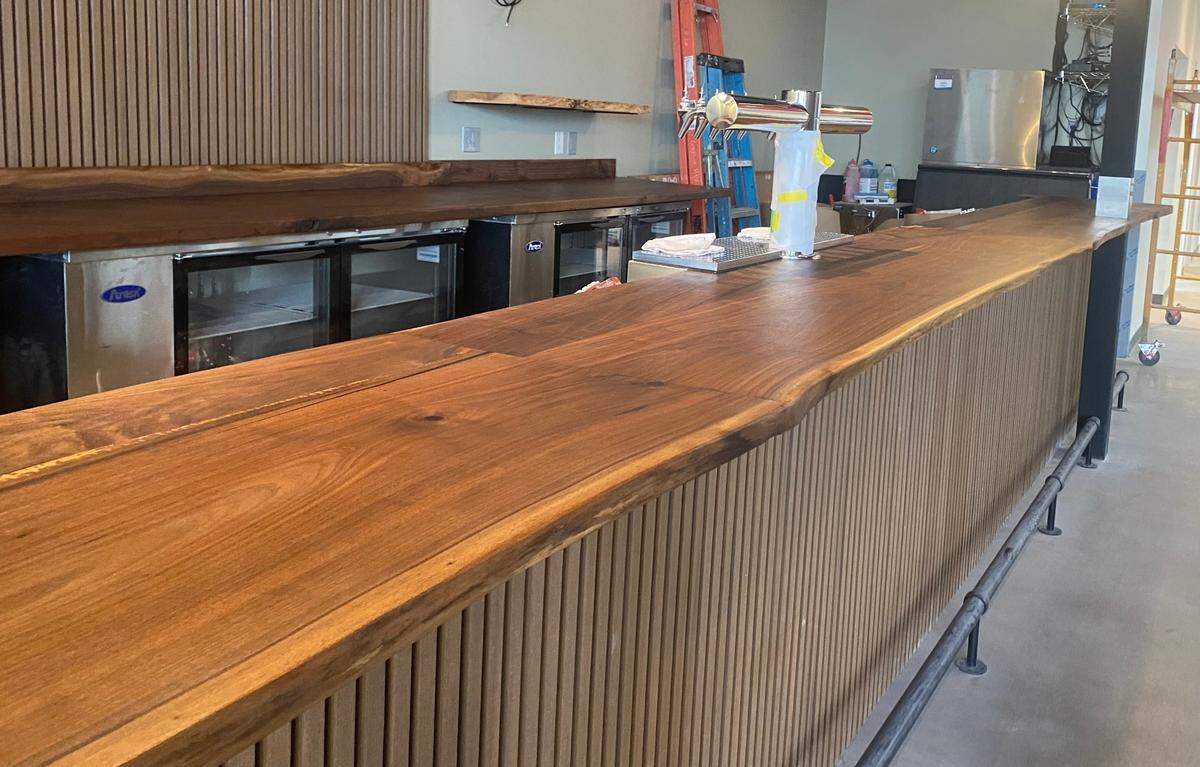 The centerpiece of the soon-to-open Red Bird restaurant in Normandie Center is a live-edge walnut bar made by a local wood craftsman.