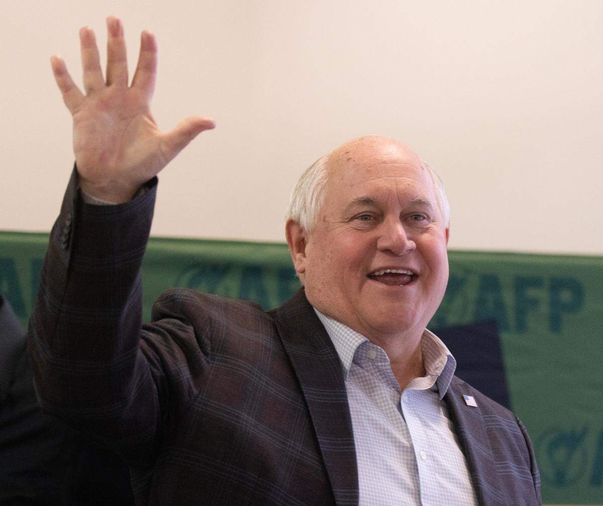 Congressman Ron Estes speaks at Union Station during a rally held by Americans for Prosperity. A group of protestors waved signs, chanted and blew whistles outside of the rally.
