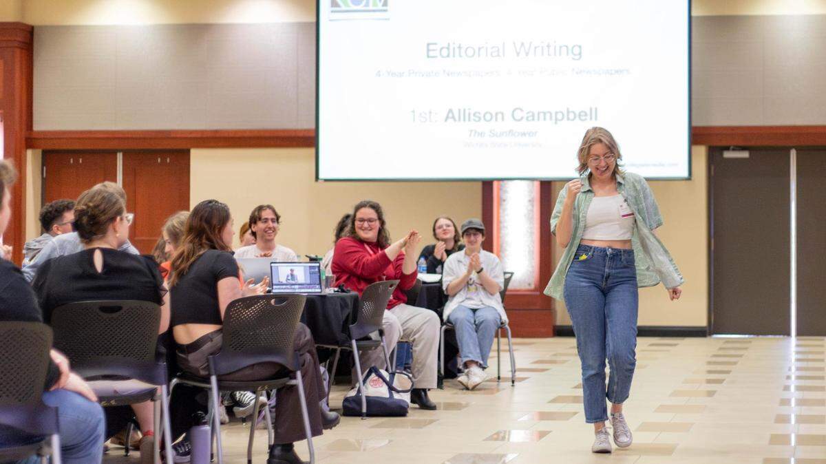 Eagle intern Allison Campbell accepting one of the many awards she’s earned for her journalism work.