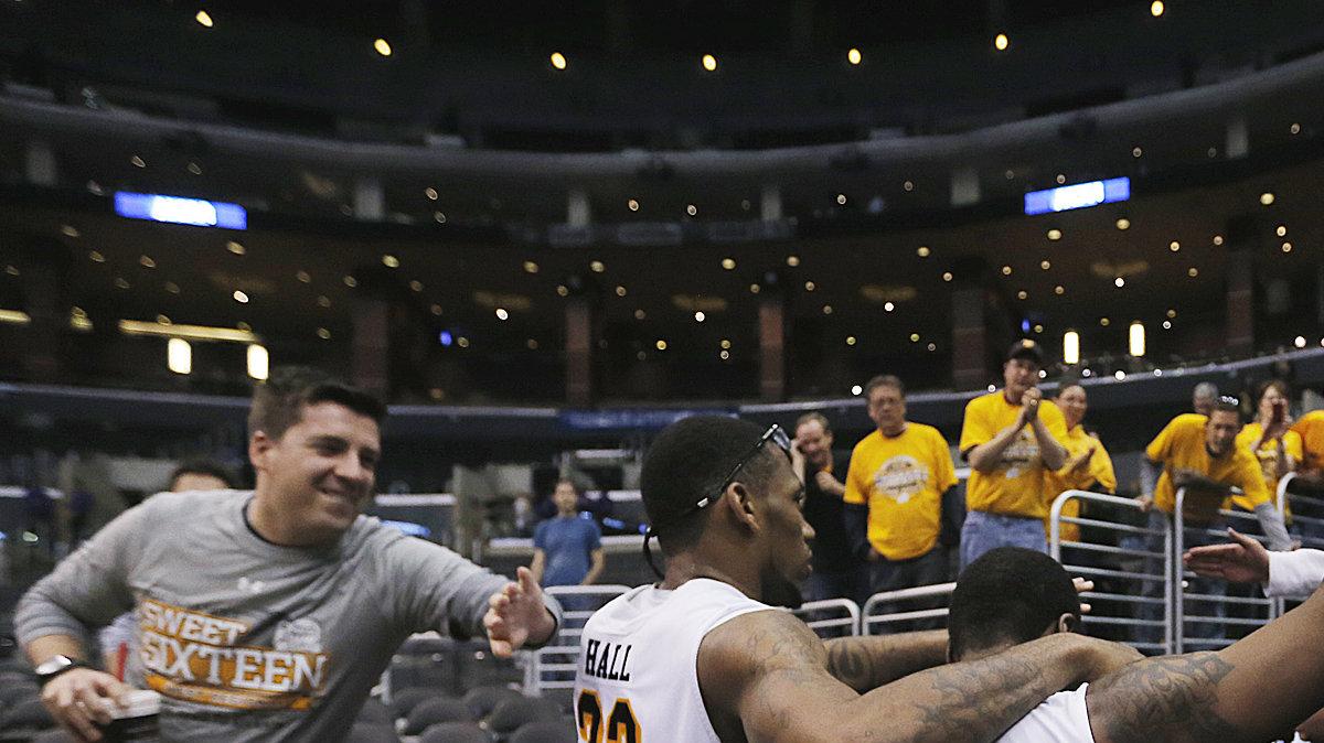 Wichita State Shockers guard Tekele Cotton (32) and Wichita State Shockers guard Malcolm Armstead (2) are high-fived by fans after they beat La Salle in the NCAA Tournament regional semifinal at Staples Center in Los Angeles against La Salle. WSU beat La Salle 72-58 and advance to the Elite Eight. (March 23, 2013)