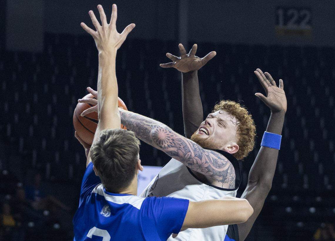 Wichita State big man Will Berg plays through contact against Drake in a scrimmage at Koch Arena.
