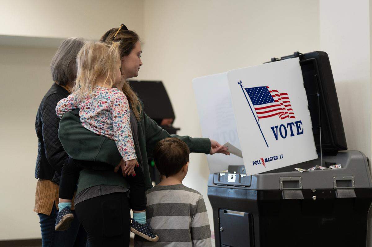 Breanna Maggart casts her vote at Grace Presbyterian Church. Voters in the Wichita school district are considering whether to approve a $450 million bond issue to modernize schools.
