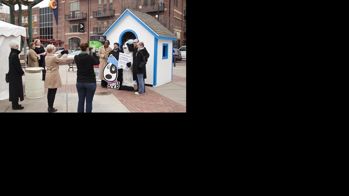 Several Wichita City Council members pose with WAMmy the ICT ArtDOG during the Art Day of Giving, a 24-hour fundraising blitz for the arts in Wichita. Waite was visiting Old Town with mom Jackie Waite.

