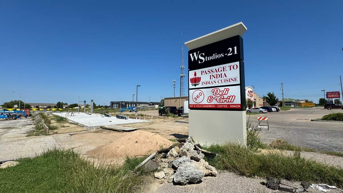 The sign for Passage to India is up near the northeast corner of 21st and Woodlawn. But the restaurant won’t open there until early next year.