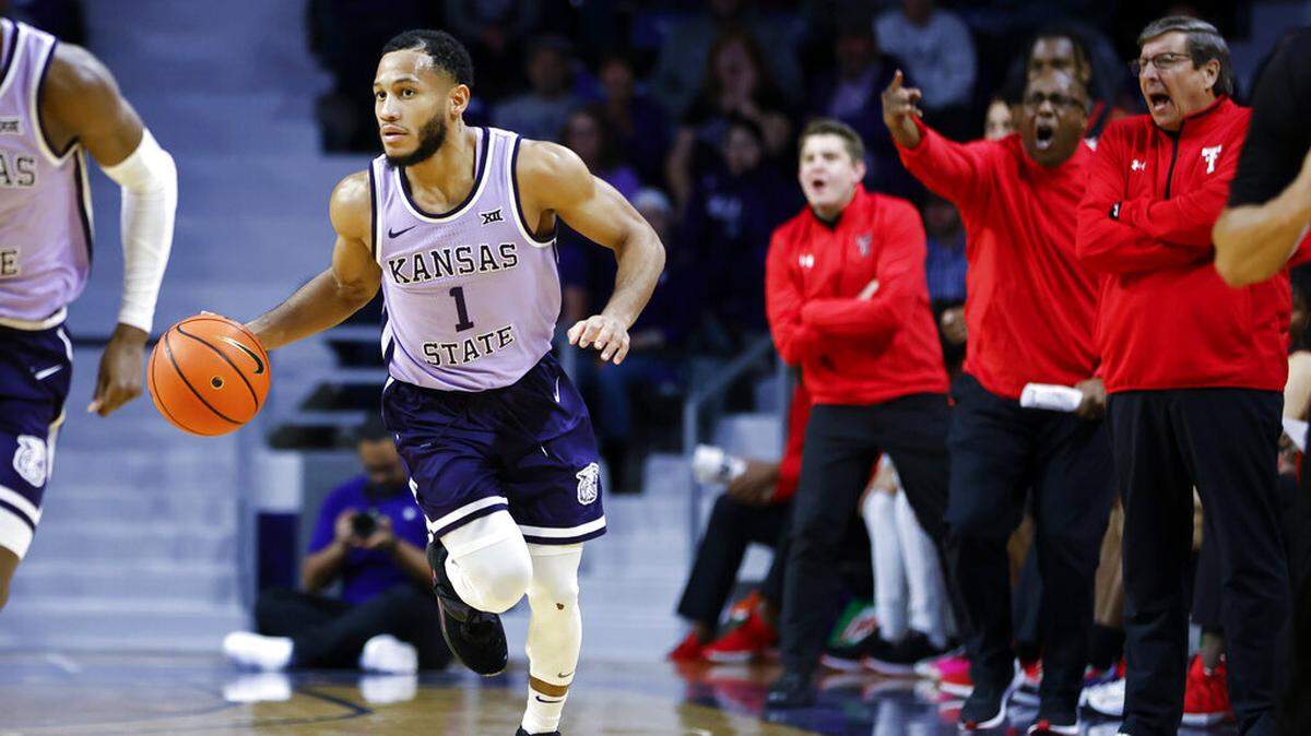 Kansas State guard Markquis Nowell (1) heads down the court as the Texas Tech bench reacts during the second half of an NCAA college basketball game, Saturday, Jan. 21, 2023, in Manhattan, Kan. (AP Photo/Colin E. Braley)