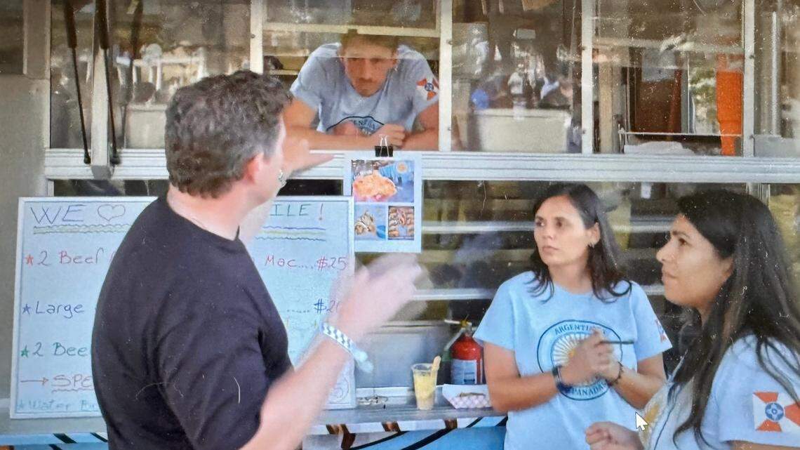 Argentina’s Empanadas from Wichita, consisting of Chad Freeman, top; Paola Mentis, second from right; and Carolina Brandan, right; get a talking to from celebrity chef and “The Great Food Truck Race” host Tyler Florence.