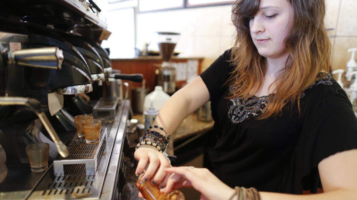 Molly Loesch serves up a drink at Mead’s Corner in 2013.