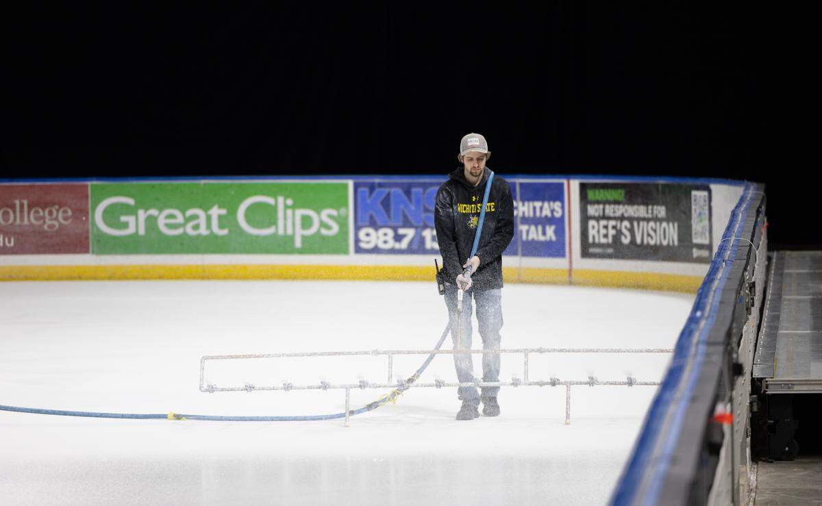 White paint is applied to the ice at Intrust Bank Arena on Thursday in preparation for the U.S. Figure Skating Championships that are coming to Wichita next week.