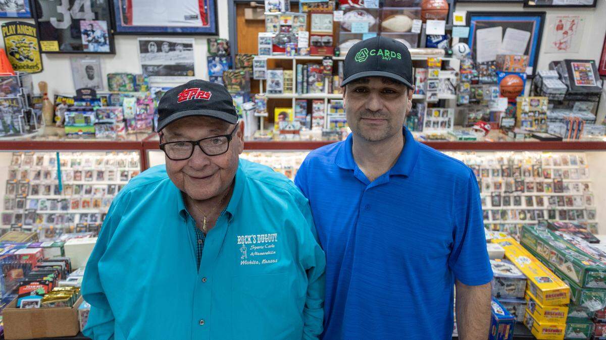 Almost half a century after opening his Rock’s Dugout sports memorabilia shop, Joe Ruocco, left, has sold the business to longtime customer Rob Guelfi.