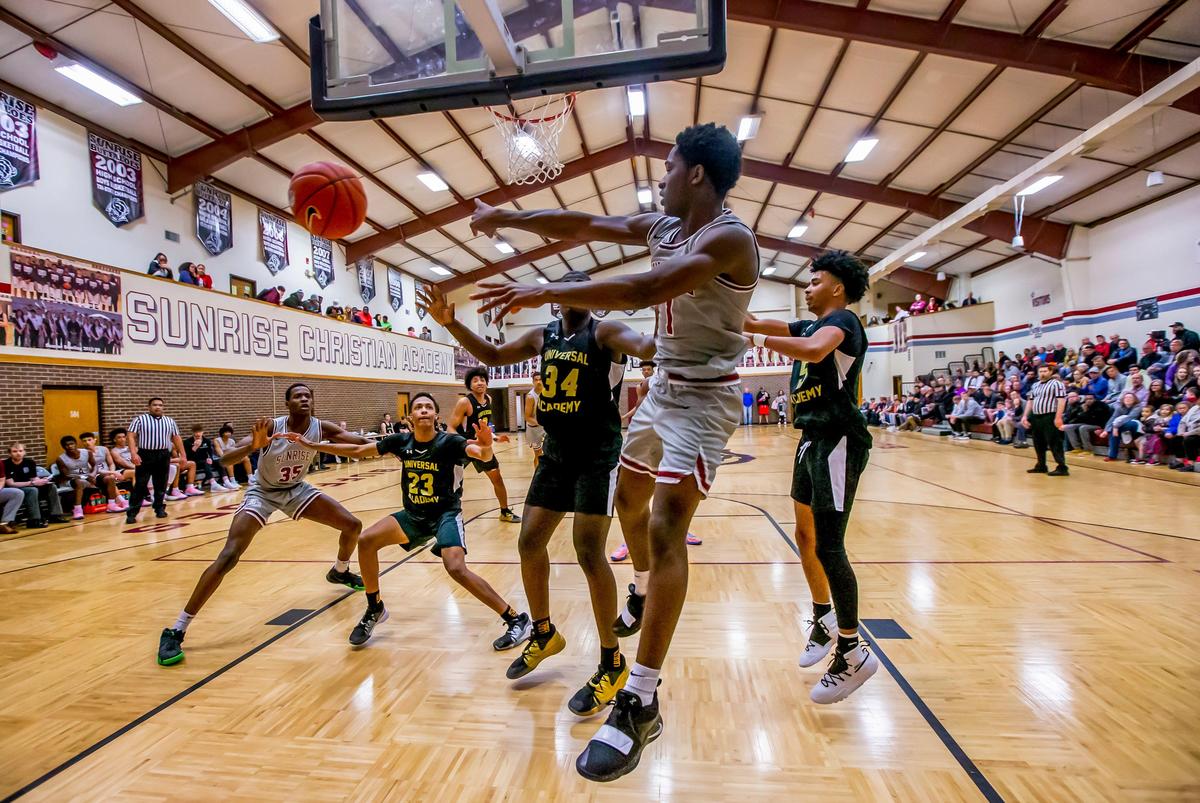 Sunrise Christian Academy’s Davonte Jennings dishes the ball after penetrating to the basket against the Universal Academy Eagles in Bel Air Thursday night. Sunrise Christian Academy just north of Wichita, has produced 76 Division I men’s college basketball players.