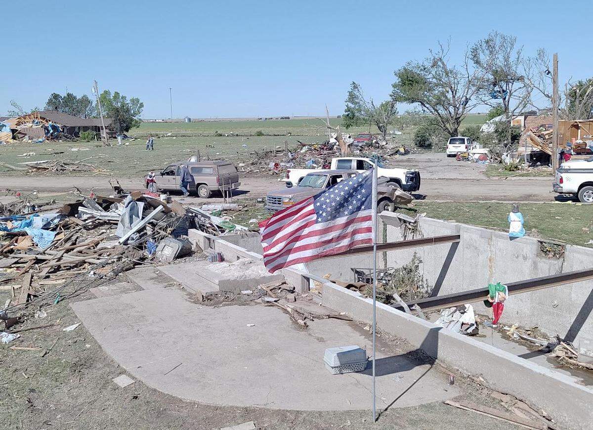 First responders and and utility crews worked Monday to clean up and restore power to Grinnell, after it was leveled by a tornado on Sunday.
