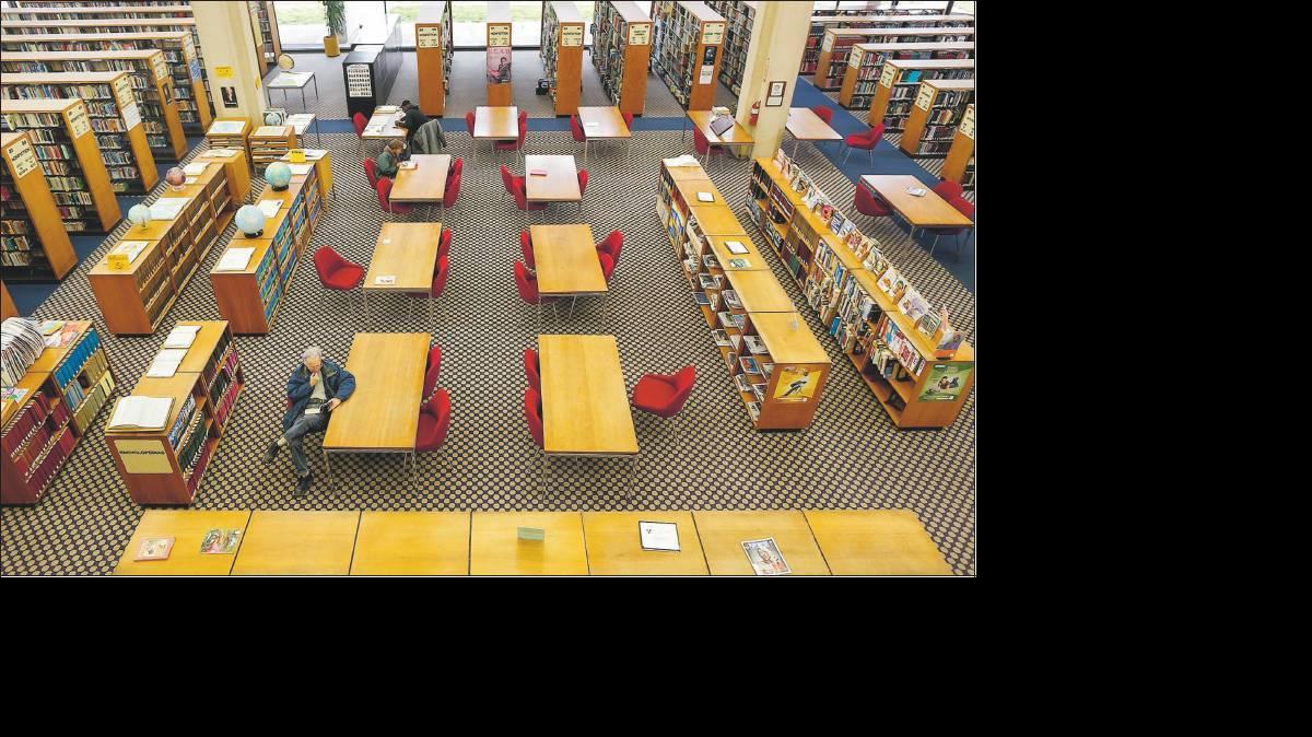 A few people spend a quiet afternoon in the downtown Wichita Central Library on South Main.