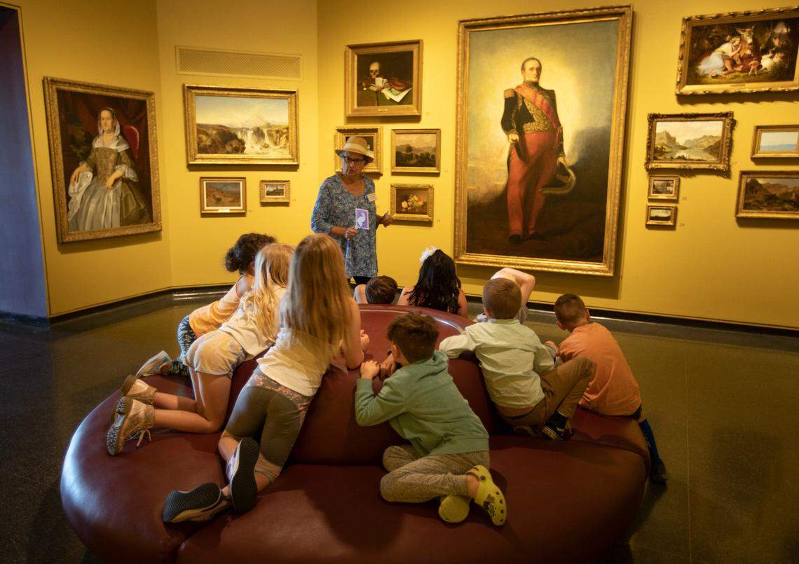 First grade students from Prairie Creek Elementary School in Andover listen to Wanda Lonnon, a docent at Wichita Art Museum, talk about the art collection on May 12, 2022. The students were displaced after a tornado hit their school on April 29, and WAM treated them to more hands-on activities and a longer stay.