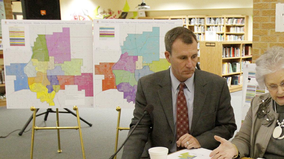 Superintendent John Allison shows Wichita school board members Sheril Logan and Barb Fuller his preliminary proposal for high school boundaries. (February 6, 2012)