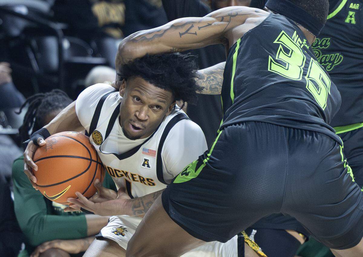 Wichita State’s Kenyon Giles tries to get around South Florida’s Izaiyah Nelson during the first half at Koch Arena on Wednesday night. 