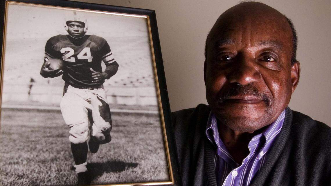 **ADVANCE FOR WEEKEND EDITIONS MARCH 30 AND 31** Veryl Switzer, holds a picture of himself at his home in Manhattan, Kan., Feb. 27, 2007. Switzer wore the number 24 at Kansas State where he was the only black player on the 1953 football team. (AP Photo/The Kansas State Collegian, Christopher Hanewinckel)