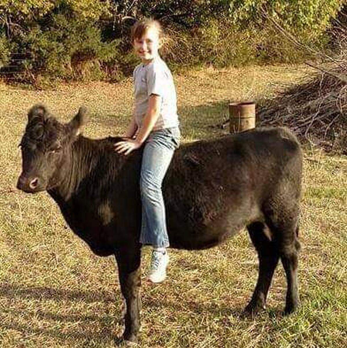 Emma Brungardt riding on her cow Clover. It was the start of a passion that led her to training and riding mustangs.