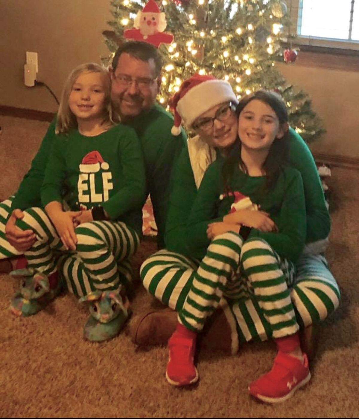 Former Coffeyville football coach Aaron Flores with his wife, Kristen, and their two daughters, Haley and Ryann.