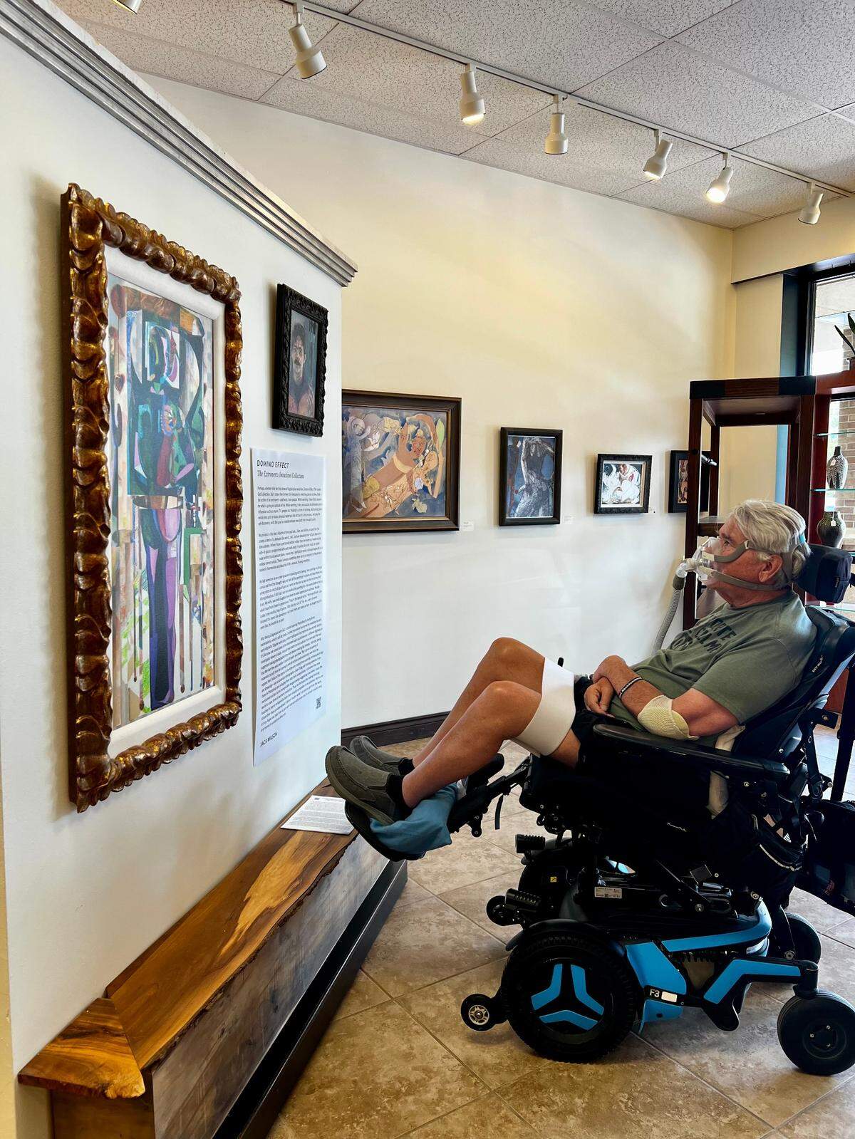 Jack Wilson looks at one of his paintings in the gallery space at the Art & Frame shop he started 30 years ago and that his daughter is now taking over. Wilson’s work is on display through July 12.