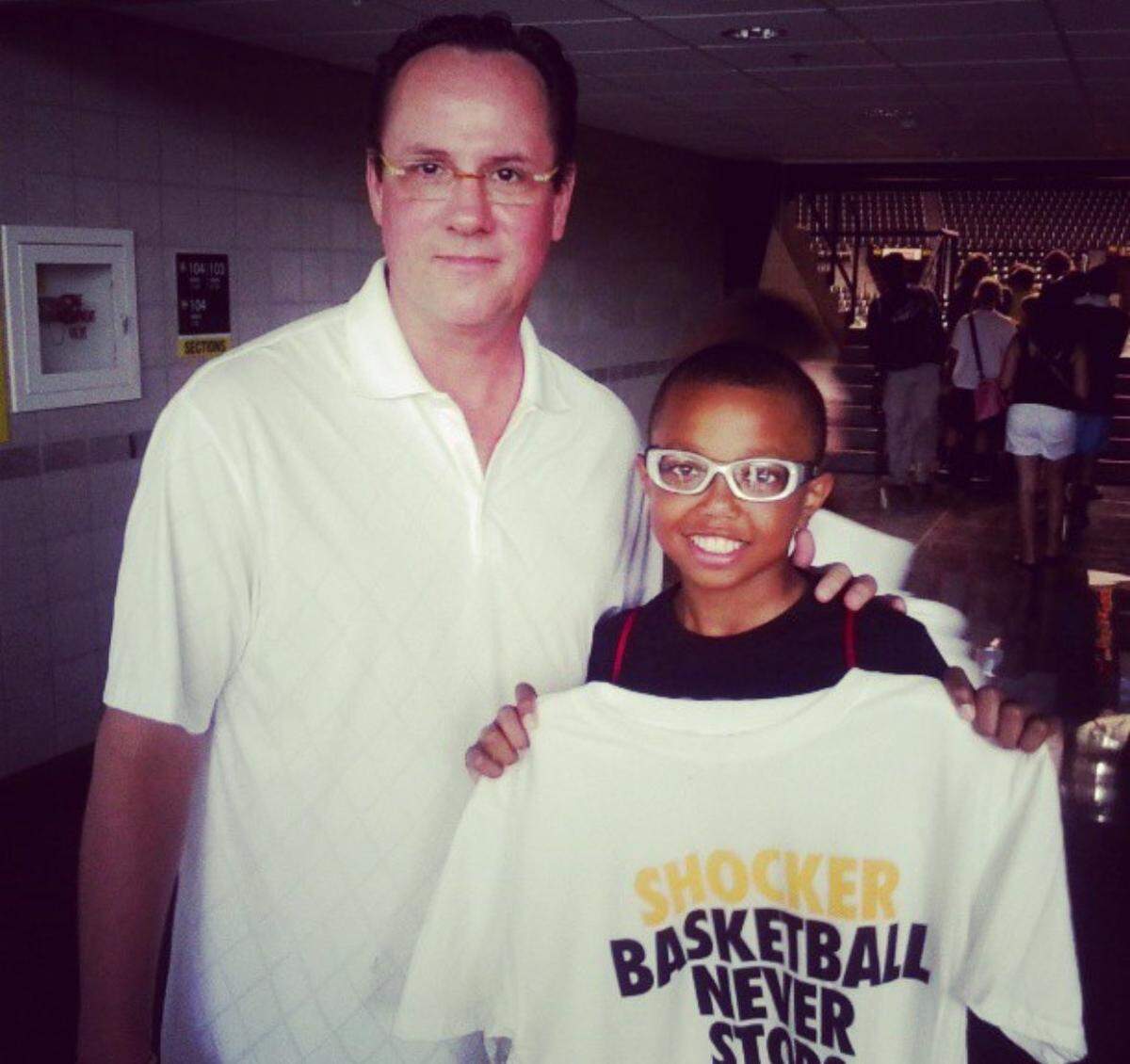 Current WSU basketball player Xavier Bell posed with a picture with former WSU coach Gregg Marshall more than a decade ago. Bell, a Wichita native, grew up a fan of the Shockers.