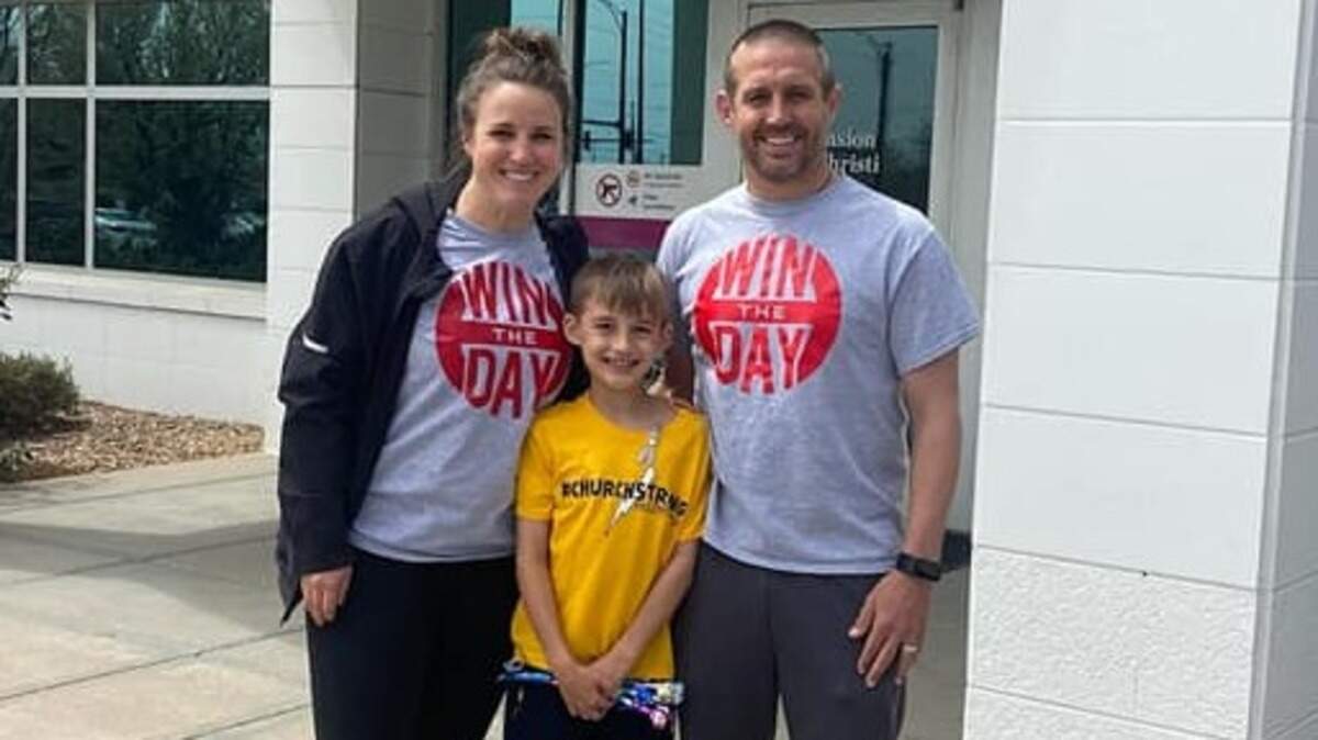 Michael Church (right), the athletic director at Wichita Heights, said he is motivated every day by his wife, Laura, and 8-year-old son, Kendric, as he battles a terminal brain cancer.
