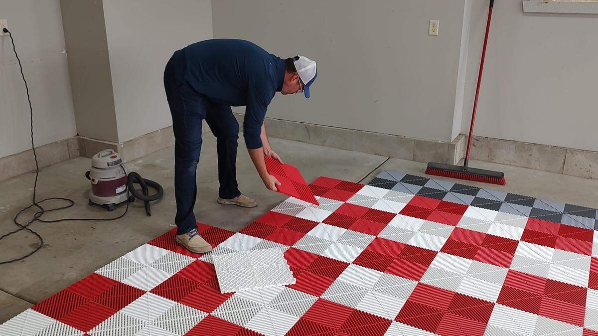 Mike Ludlow, who recently purchased Harmony Home Concepts, installs Swisstrax, a garage tile system. It’s one of several services Harmony offers.