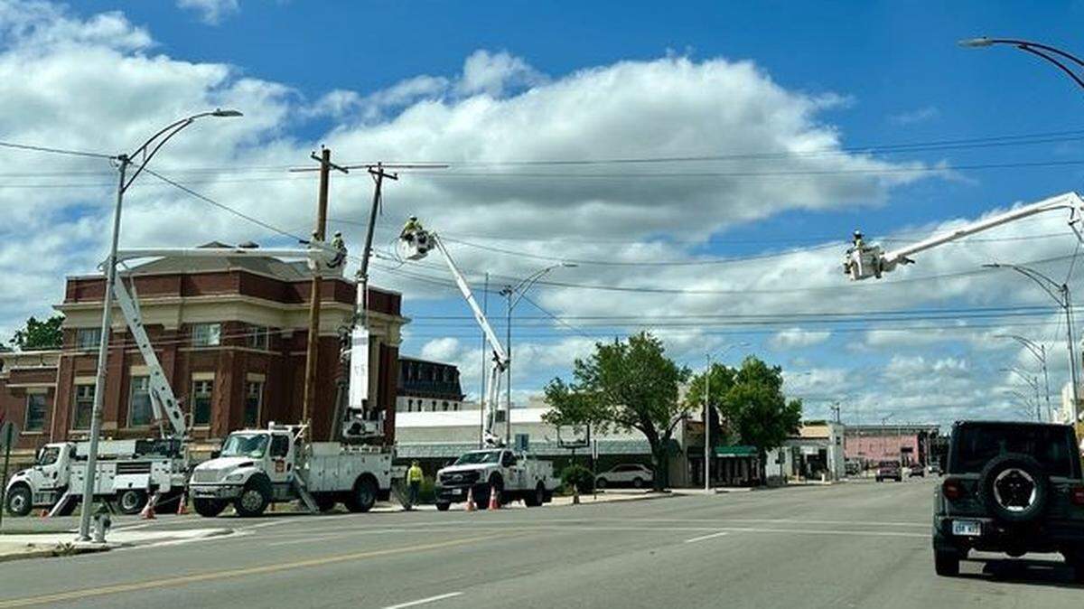 Utility workers repair power lines at 2nd and Main Street in Newton on Wednesday.