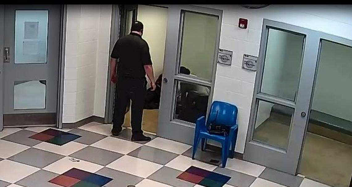 Juvenile Intake and Assessment Center employee Jason Stepien watches as Juvenile Detention Facility workers hold down Cedric Lofton in a prone restraint. This screenshot is 22 minutes into a prolonged restraint that lasted about 40 minutes.