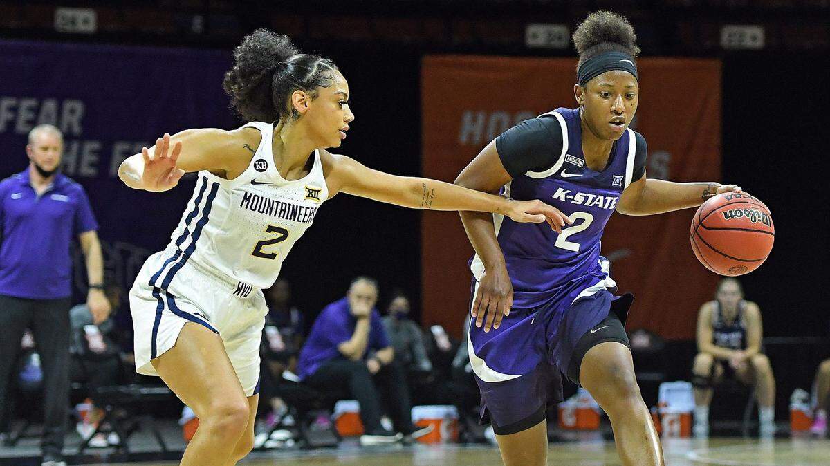 West Virginia guard Kysre Gondrezick (left) defends Kansas State gaurd Cymone Goodrich in the Big 12 women’s basketball tournament at Municipal Auditorium.