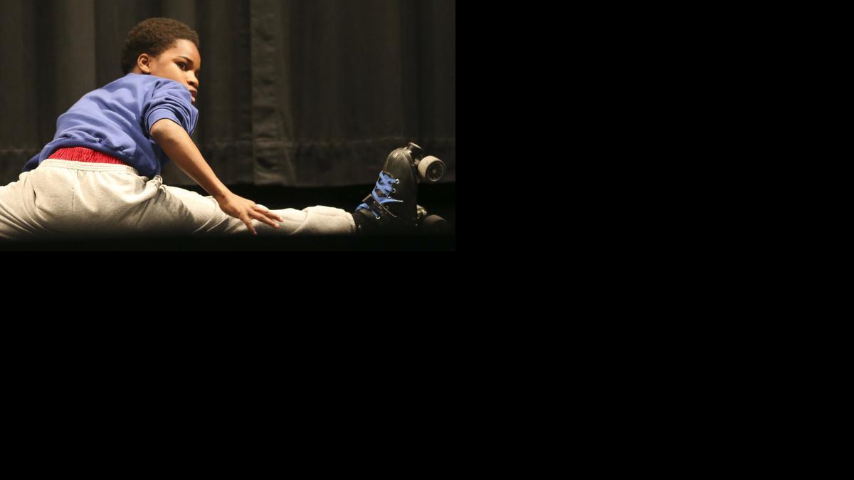Stucky Middle School’s Antony Davis ends his “One Two Step on Skates” routine with the splits during the 20th Annual YMCA Middle School After School program talent show at Marshall Middle School on Tuesday. (April 8, 2014)

