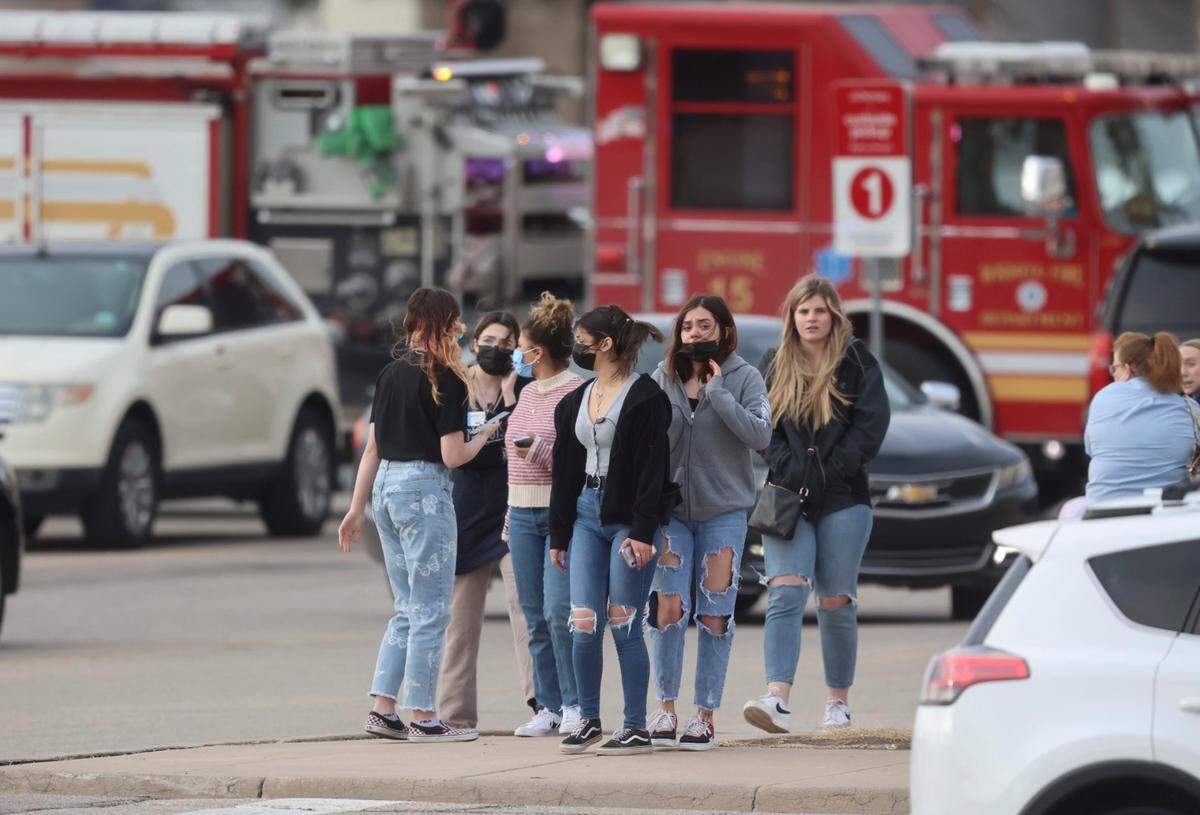 A crowd of people leave Towne East Mall where Wichita police are investigating a shooting, Wichita police spokesperson said Friday night.