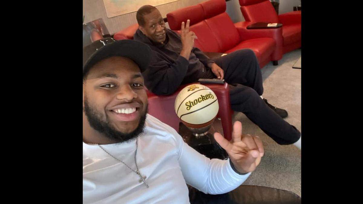 Former Shocker basketball player Lynbert “Cheese” Johnson (back) has taken an interest mentoring players who have come through Wichita, including former WSU player Jamarius Burton (front).