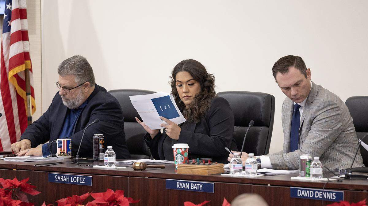 Sedgwick County commissioners Jim Howell, left, Sarah Lopez and Ryan Baty look at a report from public safety-consulting firm Jensen Hughes on Monday regarding last year’s fatal Brookhollow apartment fire. The firm concluded no single agency was responsible for the death of 22-year-old Paoly Bedeski.