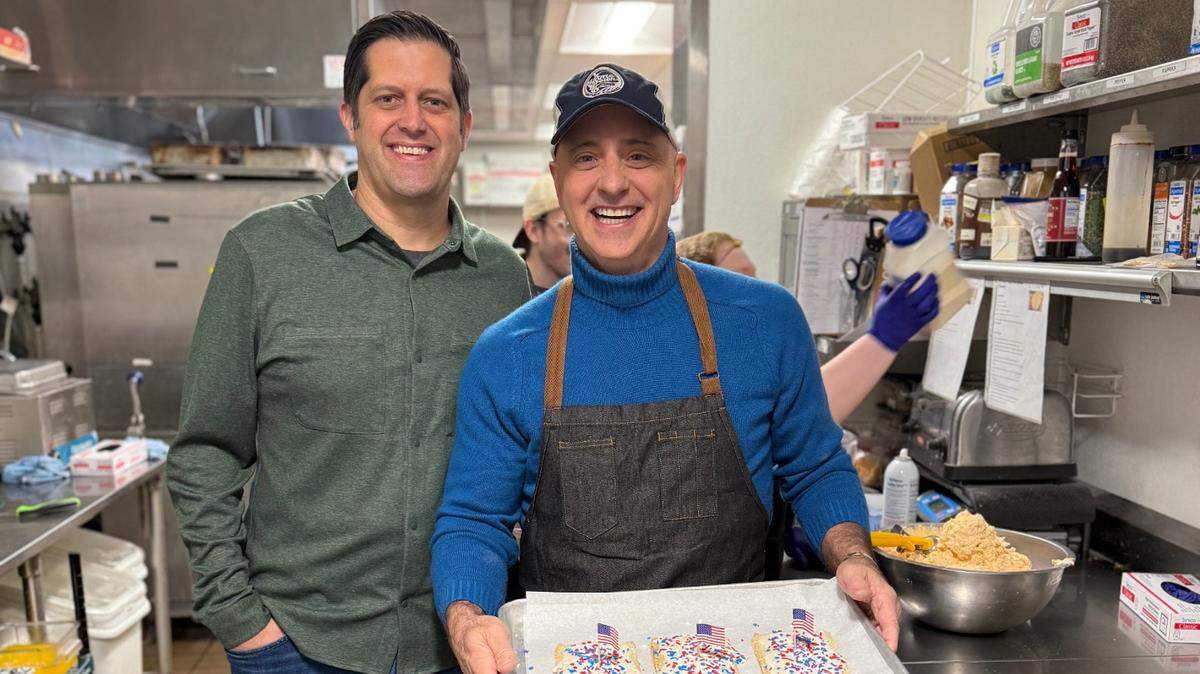 Thrive Restaurant Group CEO Jon Rolph, left, with former Olympic gold medalist Brian Boitano, who is holding a tray of pop tarts custom made for him to serve to customers. The two were raising money for youth skating and helping promote Boitano’s new cookbook.