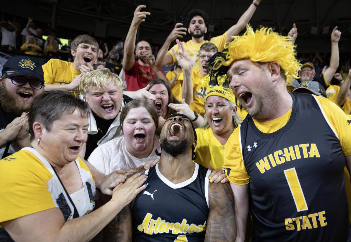 Marcus Keene celebrates with fans after his three pointer gave the Aftershocks the 66-63 win over Forever Coogs in the quarterfinal of the TBT Tournament at Koch Arena.