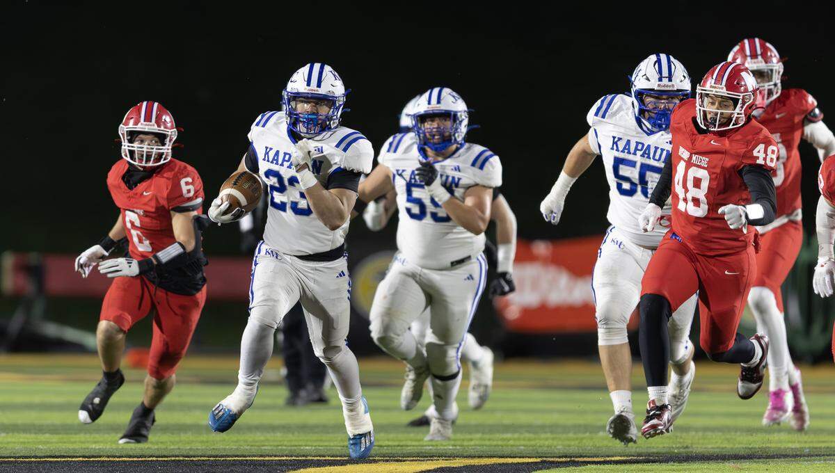Kapaun running back Kenneth Huff takes off for a long touchdown run in the second half against Bishop Miege on Saturday in Emporia. Kapaun defeated Bishop Miege 56-21 to win the 4A state title.