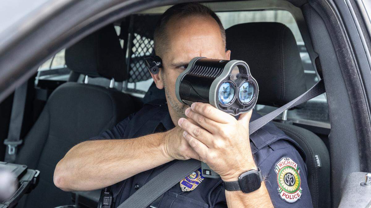 Wichita police Officer Ryan O’Neil uses a LiDAR device to check motorists’ speeds along K-15 in south Wichita.