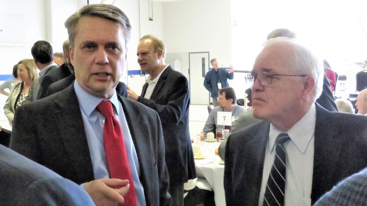 Gov. Jeff Colyer visits with Sedgwick County Commissioner Dave Unruh and others during a campaign stop in Wichita Tuesday.