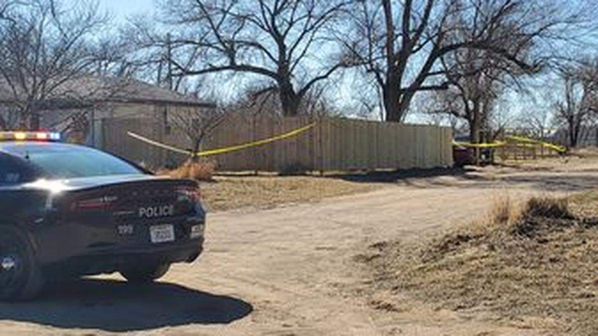 On Wednesday afternoon, Wichita police continued to block off the roads near a home in northwest Wichita where a 22-year-old man was fatally shot earlier in the day.