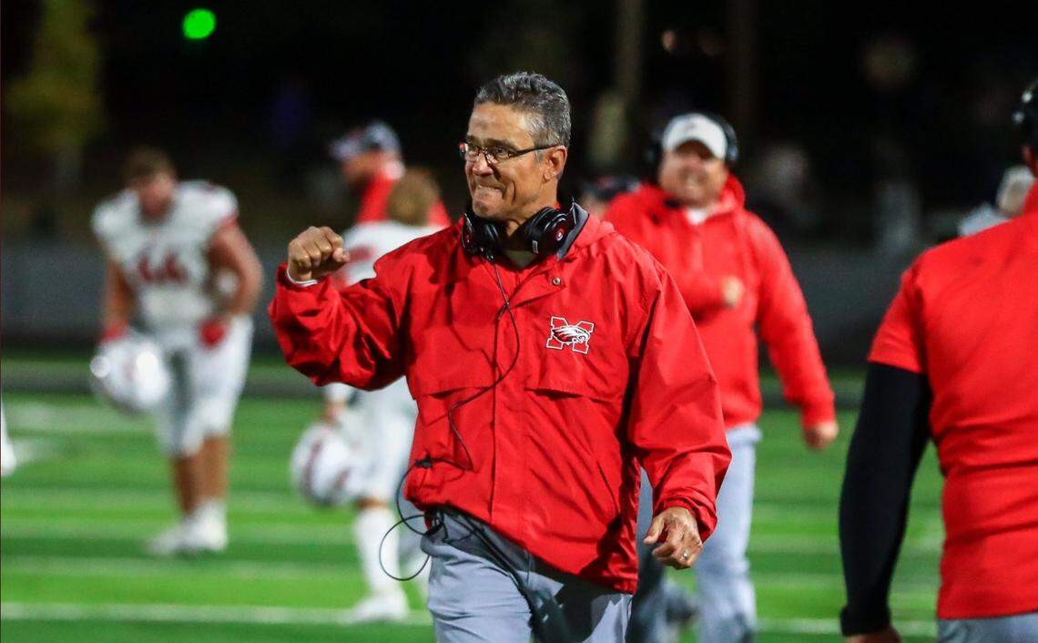 Maize coach Gary Guzman celebrates during the Eagles’ 52-51 win at Derby on Friday.