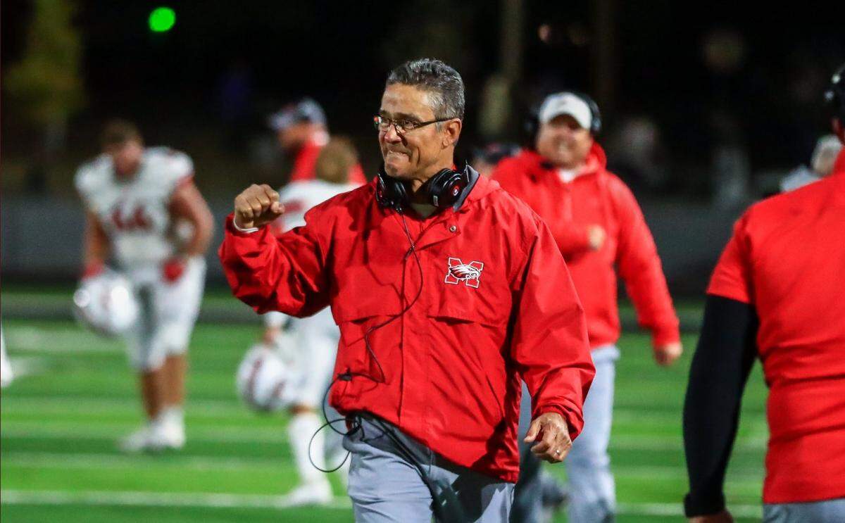 Maize coach Gary Guzman celebrates during the Eagles’ 52-51 win at Derby on Friday.