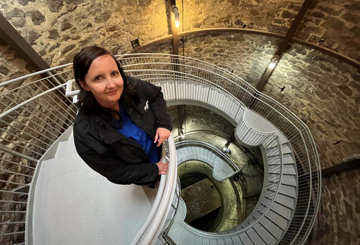 Greensburg City Administrator Stacy Barnes stands on the staircase overlooking the Big Well.