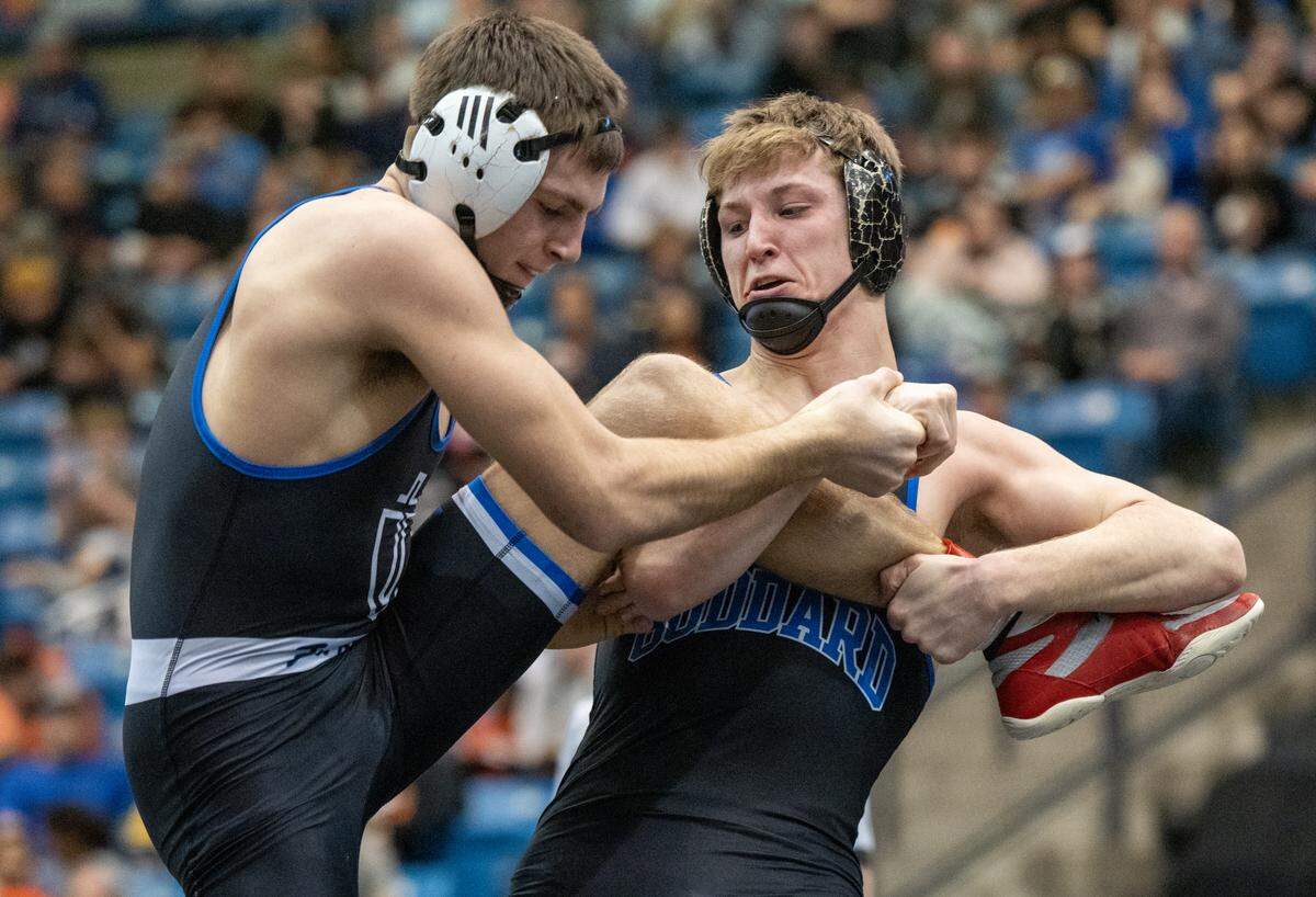 Goddard’s Kolton McElwain, right, defeated Kapaun’s Eli Koster in the 157-pound division of the 5A State Wrestling Championship at the Heartland Credit Union Arena. It is McElwain’s second state title.